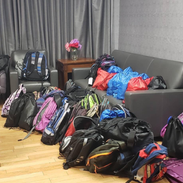A room filled with lots of bags and luggage.
